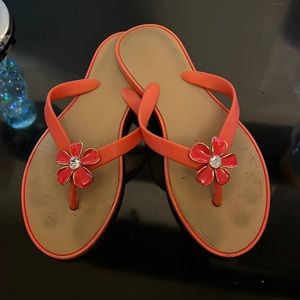 Orange sandals size 7/8 with an orange flower with gem in center